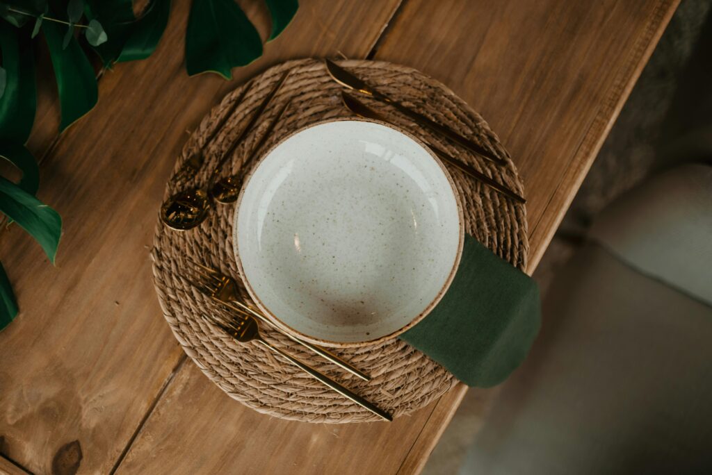 Rustic Dining Setting with Ceramic Bowl and Gold Cutlery